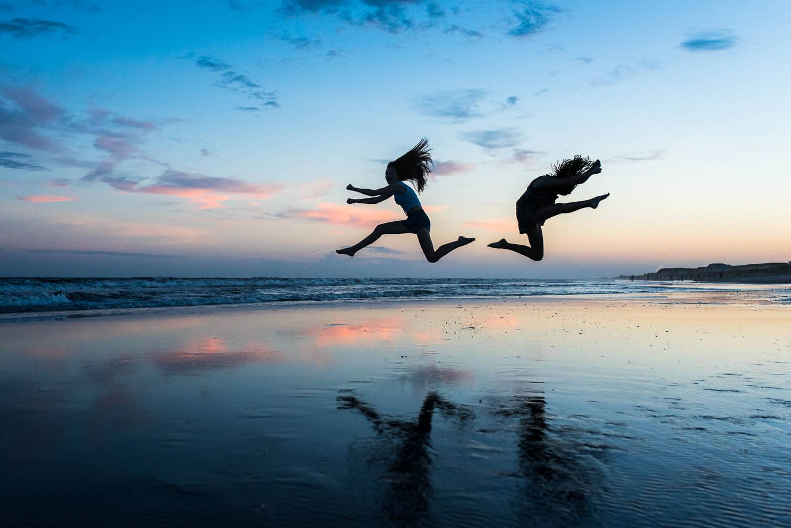 pic of two kids jumping on the beach by Susan Grimes