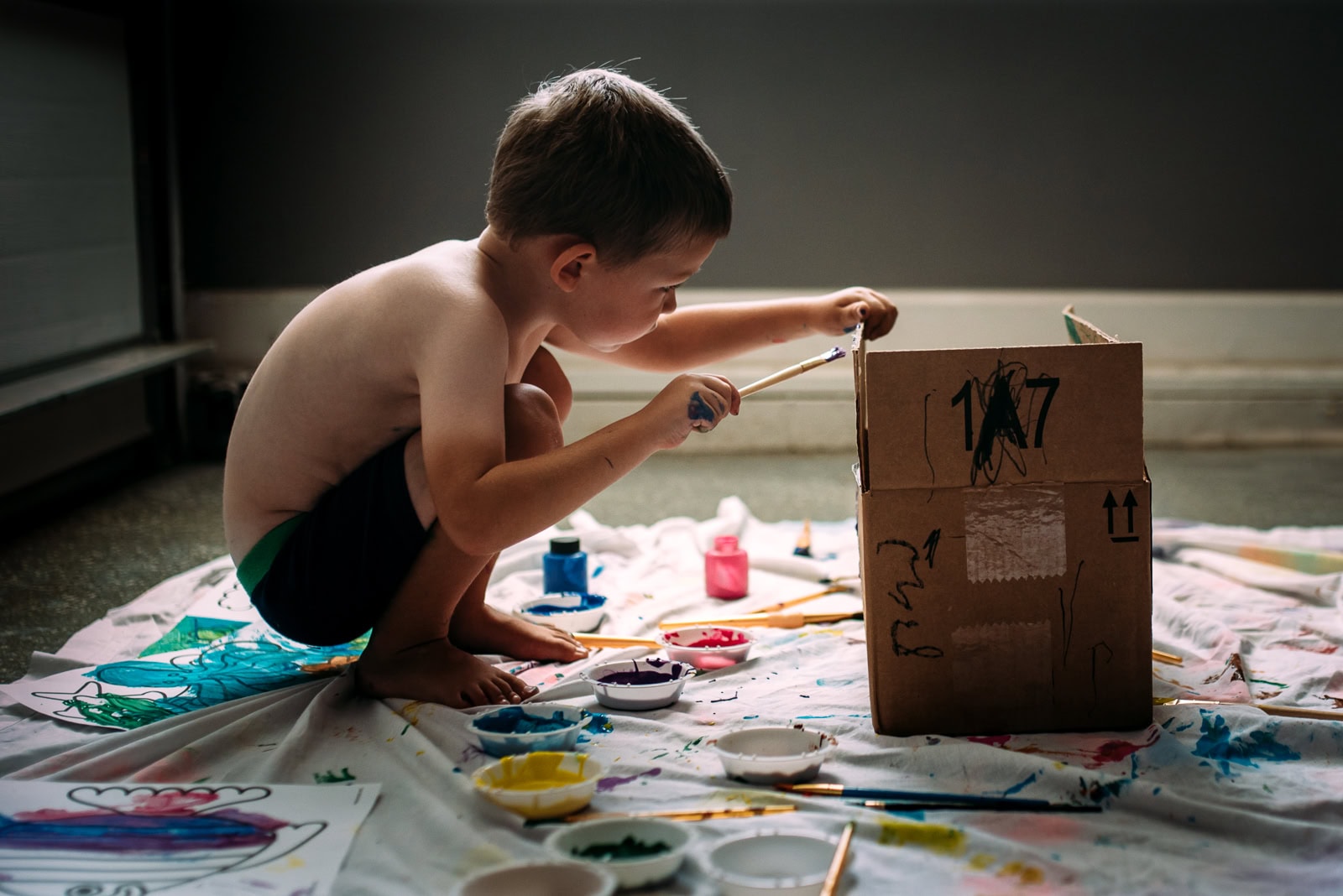 kid painting a box by Susan Grimes
